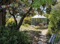 a garden with a gazebo and a bench at Adorable chalet avec jacuzzi privatif in Aix-en-Provence