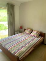a bed with two pillows in a bedroom with a window at Le Piroulet in Vassieux-en-Vercors