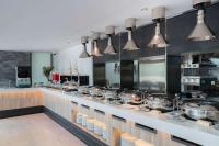 a kitchen with many pots and pans on a counter at Bayphere Hotel Pattaya JC in Na Jomtien