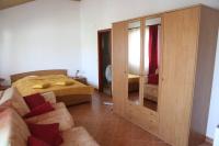 a bedroom with a bed and a large wooden cabinet at The Olive Tree in Lumbarda