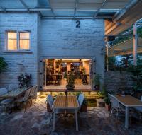 a patio with tables and chairs and a dining room at 6號花園別墅酒店 Shenzhen No'6 Garden Villa --French Window with garden view,Close to Sea World &Shekou Ferry Port &K11 Ecoast &Subway Nearby ,Offer Western food and coffee &English speaking with tour services in Shenzhen