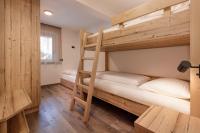 A bed or beds in a room at Apartments Pragser Wildsee Winklwiese