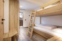 A bed or beds in a room at Apartments Pragser Wildsee Winklwiese