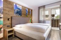 A bed or beds in a room at Apartments Pragser Wildsee Winklwiese