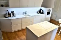 a kitchen with white cabinets and a counter top at La Maison du Quai Triplex de charme 4 étoiles en hyper centre avec SPA in Landerneau