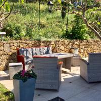 a patio with a table and chairs and a stone wall at bienvenue chez Alain et Marie in Antibes