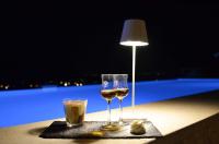 une table avec deux verres de vin et une lampe dans l'établissement Relais Villa Olivi, à Costermano