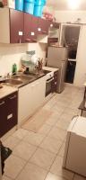 a kitchen with a sink and a refrigerator at A 20 minutes de Paris in Sarcelles