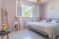 a bedroom with a bed and a ladder and a window at Les Vergers in Gonfaron