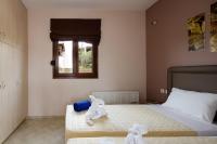 Posteľ alebo postele v izbe v ubytovaní Villas Roumeli