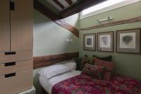 A bed or beds in a room at Amazing penthouse with terrace and rooftop in Trastevere