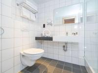 a white bathroom with a toilet and a sink at Mercure Cardiff North Hotel in Cardiff