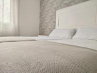 A bed or beds in a room at Second Home Arzúa apartamentos