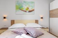 Postel nebo postele na pokoji v ubytování Apartment Nilda II