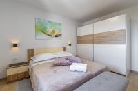 Postel nebo postele na pokoji v ubytování Apartment Nilda II