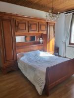 a bedroom with a large bed with a wooden headboard at Domaine du gros pata in Vaison-la-Romaine