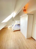 a attic room with a bunk bed and a closet at Cosy 2-Bedroom Apartment in the center of Hotton in Hotton