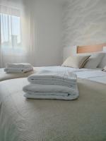 A bed or beds in a room at Second Home Arzúa apartamentos