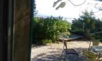 a view of a table and chairs from a window at Appartement d&#39;une chambre avec vue sur la mer jardin amenage et wifi a Hyeres a 2 km de la plage in Hyères