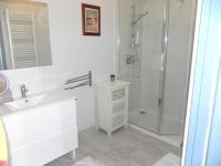 a white bathroom with a shower and a sink at Appartement de 3 chambres a Les Sables d&#39;Olonne a 800 m de la plage avec wifi in Les Sables-d&#39;Olonne