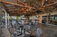 a restaurant with tables and chairs and a bar at Bayfront Inn 5th Avenue in Naples