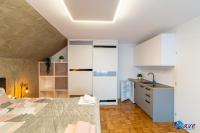 a bedroom with a bed and a kitchen with a sink at MODERN apartments WAVE near the AIRPORT in Velika Gorica
