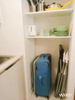 a blue suitcase is sitting in a kitchen closet at STUDIO VIEIL ANTIBES Marché Provençal in Antibes