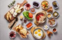 a table with plates of food and bowls of food at Yeşilyurt Park Otel in Corlu