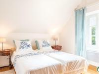 a bedroom with a large white bed with blue curtains at Gîte Montépilloy, 3 pièces, 4 personnes - FR-1-526-30 in Montépilloy