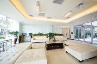 a large living room with white furniture and large windows at Sunseed International Villa Hotel in Chiayi City