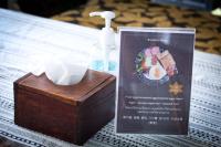 a wooden box sitting on a table with a bottle of soap at Vlodge House in Chiang Mai