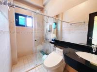 a bathroom with a toilet and a shower and a sink at Qixingtan Xinghai B&amp;B in Dahan