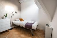 a small bedroom with a bed and a lamp at Het Lichthuis in Zandvoort