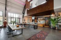 a large room with tables and a kitchen at Het Lichthuis in Zandvoort