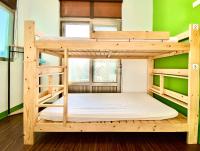 a bunk bed in a room with green walls at 澎湖北吉光背包客民宿 Bayhouse Hostel Penghu in Magong