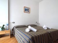 Łóżko lub łóżka w pokoju w obiekcie Village Bazzanega - Montagnoli Group
