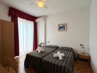 Łóżko lub łóżka w pokoju w obiekcie Village Bazzanega - Montagnoli Group