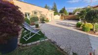 a white lawn chair sitting in the driveway of a house at Les chambres du Bonheur in Fontaine-sous-Jouy