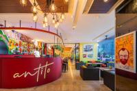 a restaurant with a red counter and tables and chairs at Eastin Grand Hotel Sathorn in Bangkok