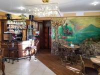 a restaurant with a large painting on the wall at Едем in Skhidnitsa