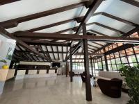 a large room with wooden ceilings and windows at Aparthotel Plat in Mlini