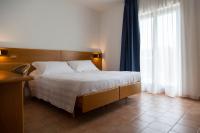 A bed or beds in a room at Hotel Villa Paradiso