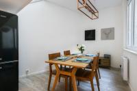 a dining room with a table and chairs and a refrigerator at Large and calm flat in the heart of Lille - Welkeys in Lille