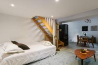 a bedroom with a bed and a wooden staircase at Large and calm flat in the heart of Lille - Welkeys in Lille