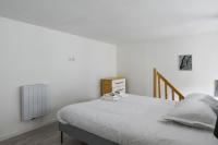 a white bedroom with a bed and a radiator at Large and calm flat in the heart of Lille - Welkeys in Lille