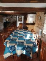 a dining room with a blue and white table and chairs at Proche baignade, La Bergerie de Claire in Thoiras