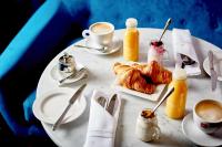 a white table with croissants and a cup of coffee at ABode Manchester in Manchester