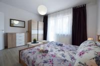 Łóżko lub łóżka w pokoju w obiekcie Katy Apartment