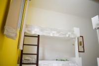 a bunk bed with a ladder in a room at Hotel Marina Clube de Pesca in Cananéia