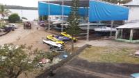 a group of motorcycles parked on a dirt road at Hotel Marina Clube de Pesca in Cananéia